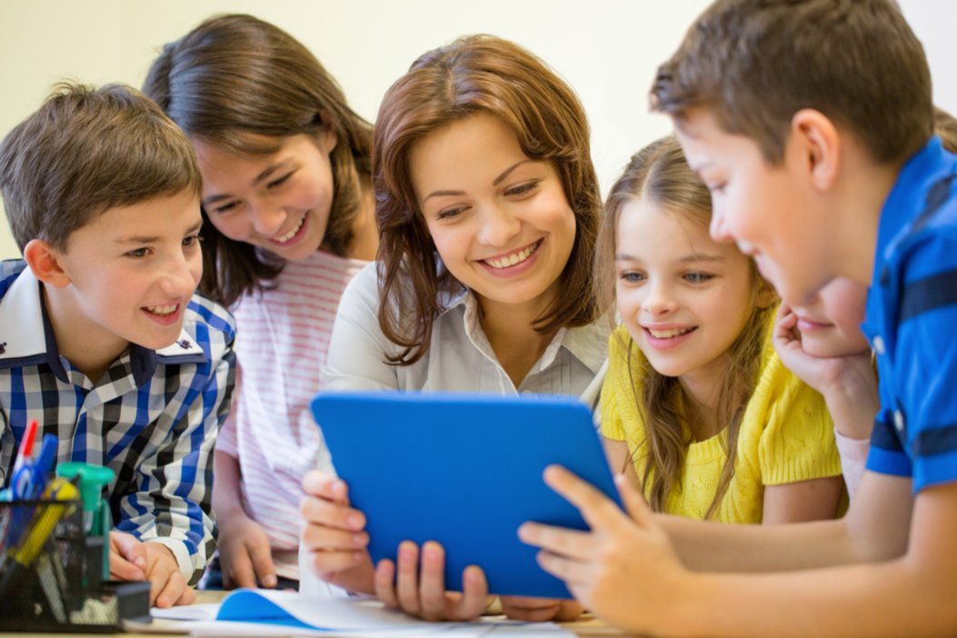 Woman and children smiling and watching the table